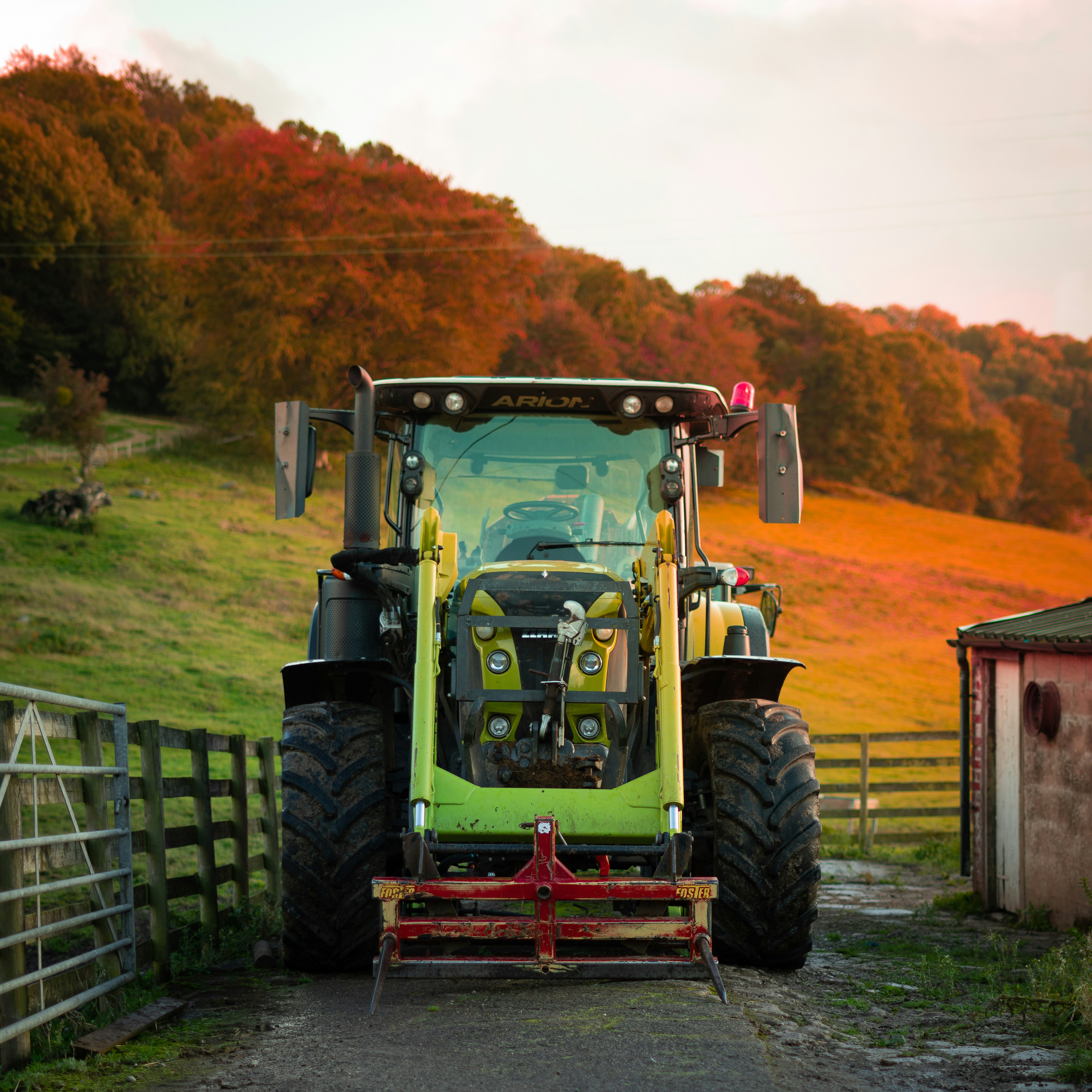 tracotor spraying water on rows of crops